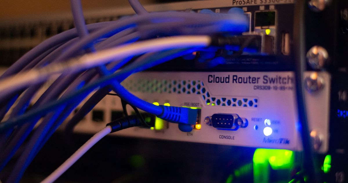 Close-up of a business network switch with connected Ethernet cables